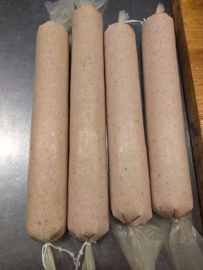Four long stick of emulsified pork in a bologna style