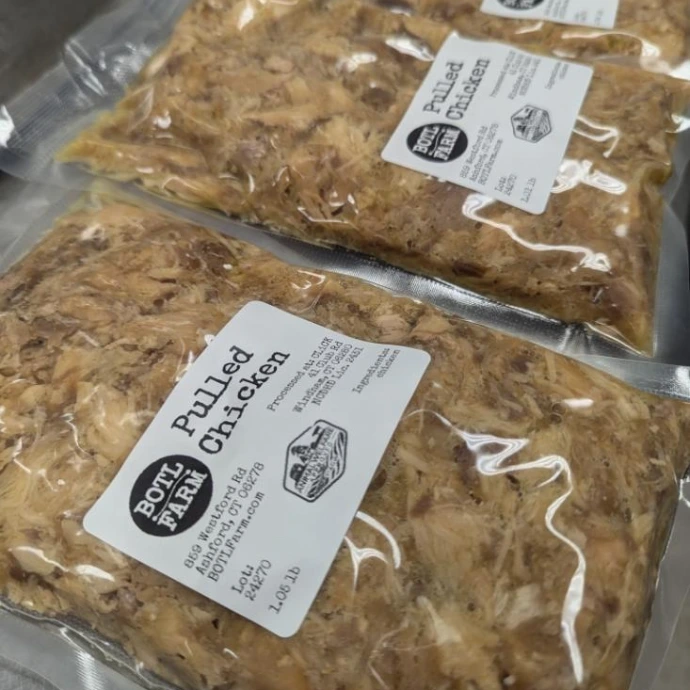 packages of pulled chicken at a commercial kitchen